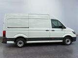 the white van is parked in a parking lot on a cloudy day