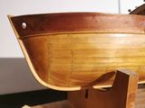 a wooden boat that is on display on a table