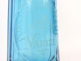 a blue glass bottle with a black lid