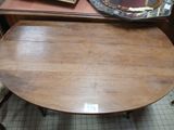 a wooden table with a mirror on top of it