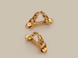 two pairs of gold - plated metal clips on a white background