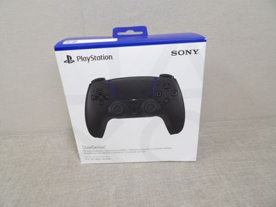 the box for the sony game controller is open on the table