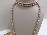 a close up of a necklace on a mannequin on a table
