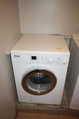 a washer and dryer in the corner of a room