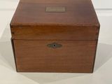 an old wooden box sitting on top of a white surface