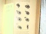 an open book with a yellow sticker attached to it