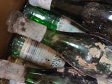 many bottles of wine sitting in a box on the floor