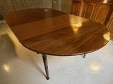 a table that has a wooden top and metal legs