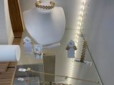many necklaces and bracelets on display in a store