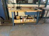 a workbench with tools on it in front of a window