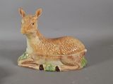 a ceramic animal that is sitting on the ground