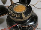 a black telephone sitting on top of a white table