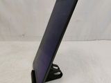 a tablet that is sitting on a stand on a table