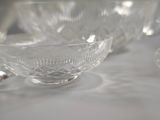 a lot of glass cups and saucers on a table