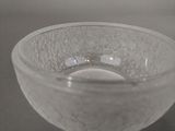 a clear glass bowl with bubbles in it on a table