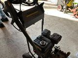 a man standing next to a machine in a garage
