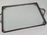 a silver tray with a handle on a white table