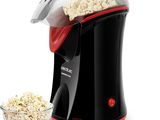 une image représentant une machine à pop-corn avec un bol de pop-corn à côté