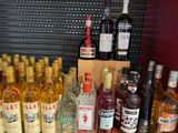 many bottles of alcohol sitting on a table