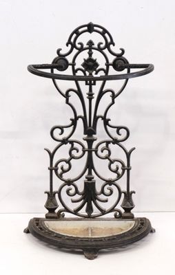 an antique cast iron shelf with a marble top on a white background