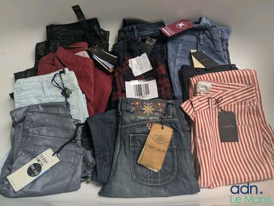 several pairs of men ' s jeans are stacked on top of each other
