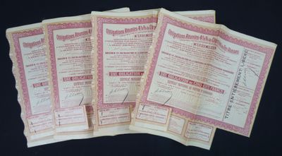 five old paper certificates are stacked on top of each other