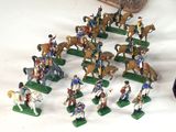 many figurines of people riding horses and horses