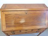 a small wooden desk with a drawer on top of it