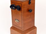 a small wooden box with a handle on it