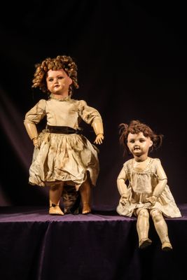 two dolls that are sitting on a table