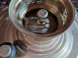 a silver cup sitting on top of a silver plate
