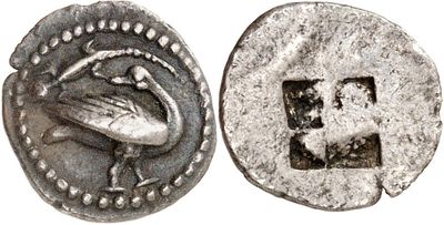 a close up of a silver coin with a bird on it