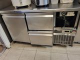 a small kitchen with stainless steel appliances and appliances on the counter