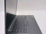 a laptop computer that is open on a white surface