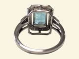 an image of a ring with a blue stone in it