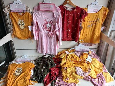 a lot of clothes that are on display in a store