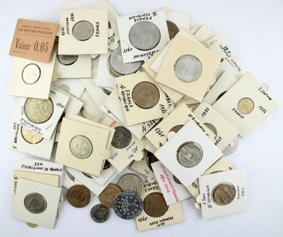 a pile of old coins on a white surface