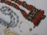 a lot of beads and bracelets on a table