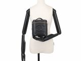 chanel black leather backpack on mannequin torso with black gloves