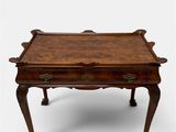 a small wooden table with a drawer on top of it