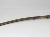 an old sword with a wooden handle on a white surface