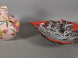 two small vases sitting next to each other on a table
