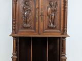 an old wooden bookcase with carvings on the front and sides