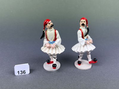 two figurines of a man and a woman dressed in traditional clothing