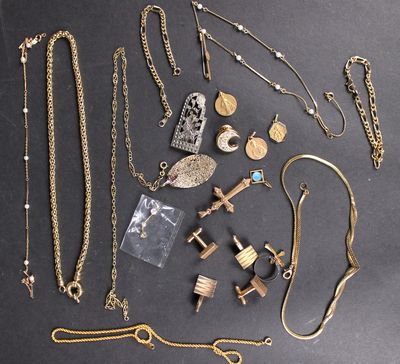 a lot of gold jewelry on a black table