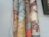 many rolls of fabric on a table next to a pair of shoes