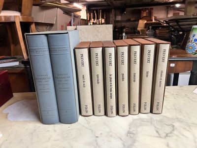 a lot of books on a table in a room