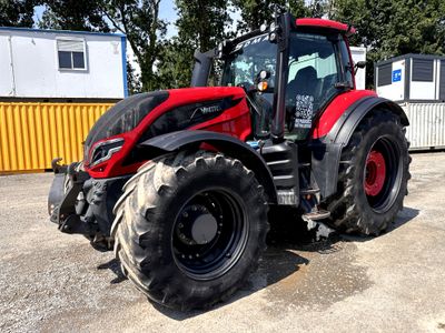 a red tractor that is parked in a parking lot