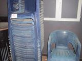 two plastic chairs sitting next to each other in a room