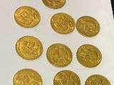 a close up of a bunch of gold coins on a table